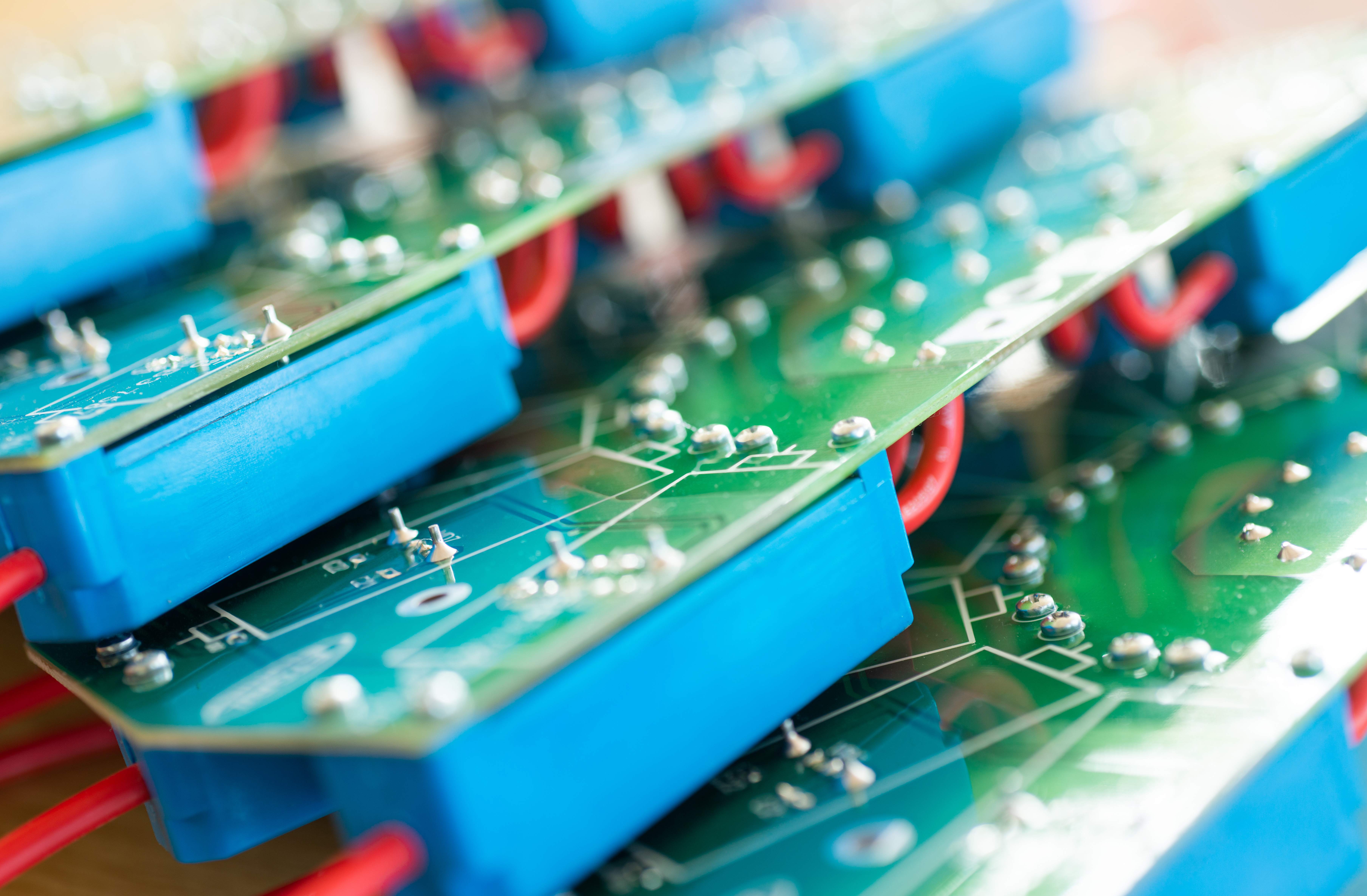 close up of a large green microcircuit with blue components