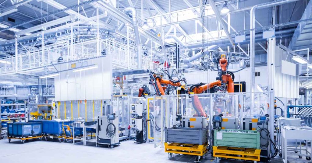 Automated PCB assembly line at BENCOR's facility, featuring robotic arms and advanced machinery, showcasing the company's commitment to efficiency and cost reduction.