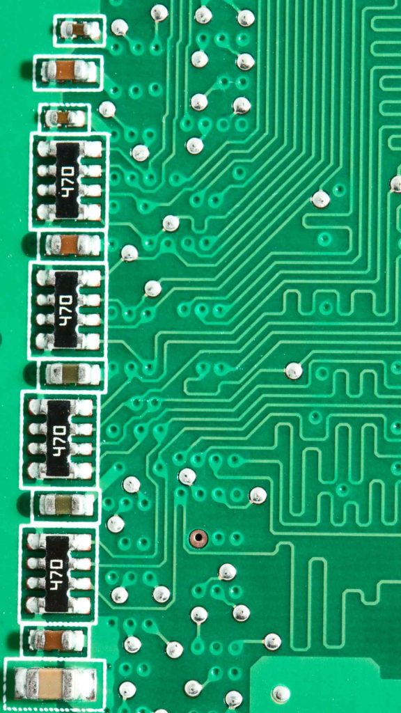 Close-up of a green printed circuit board (PCB) showing four surface-mount resistors labeled "470" in a vertical row on the left, with various traces and vias visible.