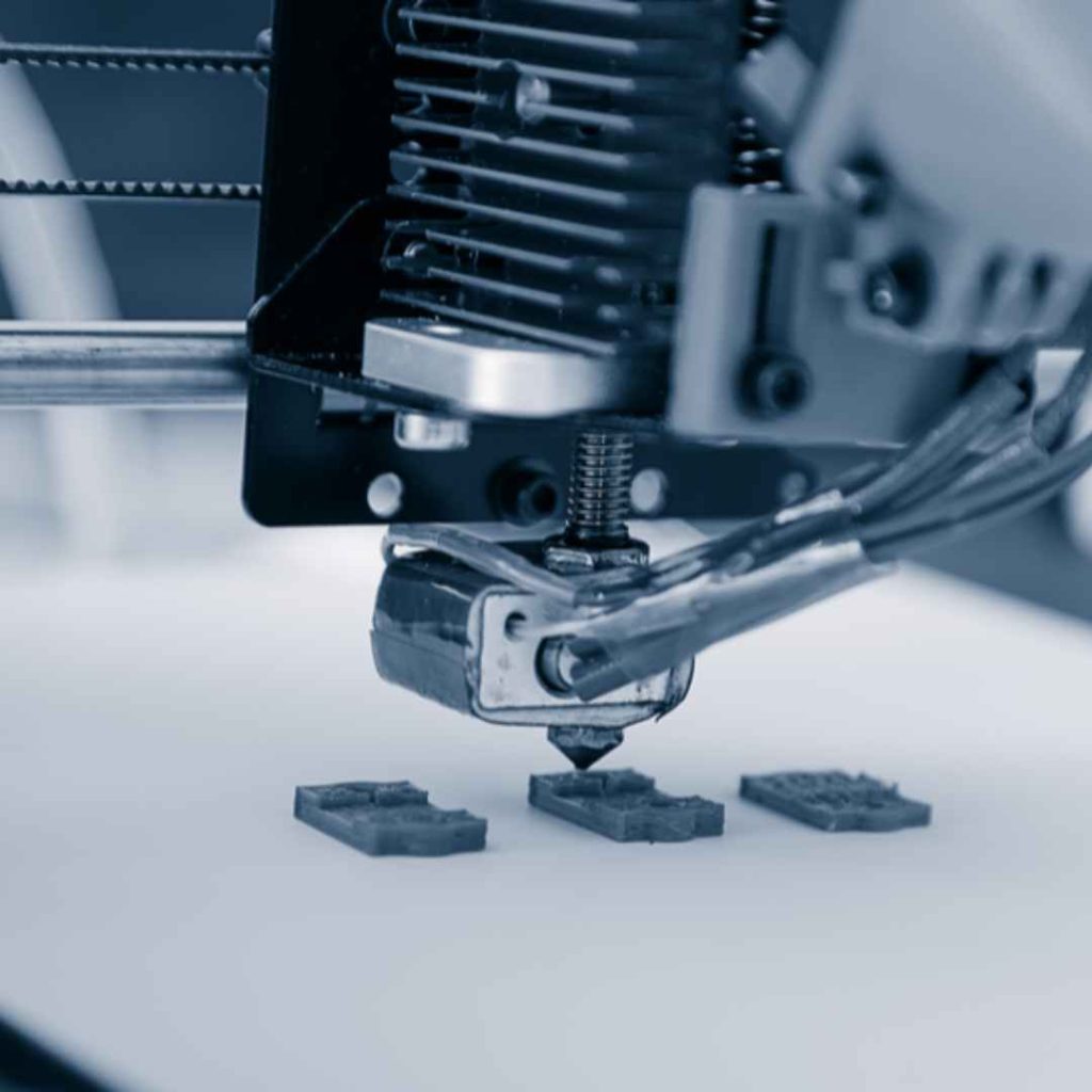 A 3D printer nozzle building small objects layer by layer, demonstrating additive manufacturing as an innovative technology influencing advancements in circuit board printing and PCB fabrication.