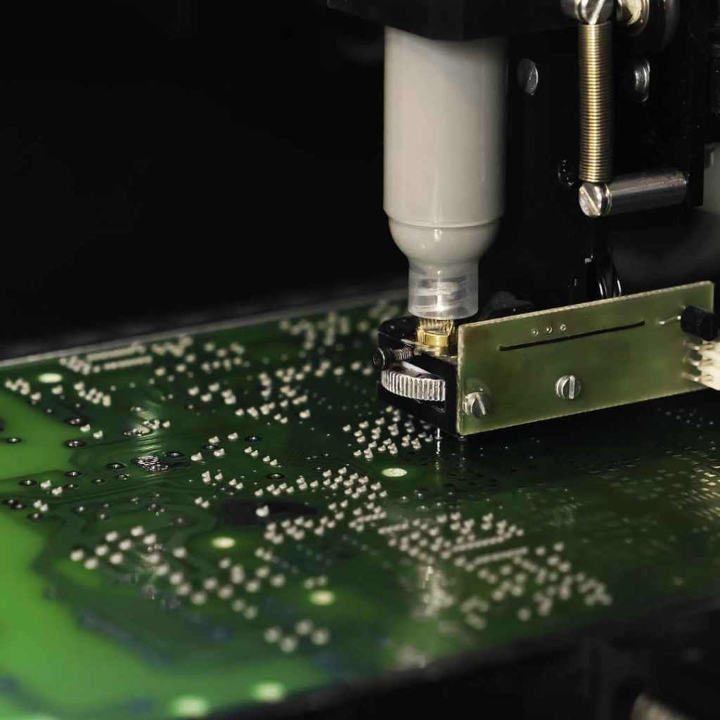 Automated machine precisely dispensing solder paste onto a circuit board, a key process in SMT assembly and an advancement in PCB printing technology.