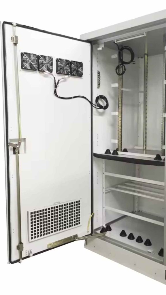 Optimizing Airflow: Integrating Centrifugal Fans and Axial Fans in Your Electronic Enclosures 5 An open electronic enclosure with three axial fans and a ventilation grille on its door, demonstrating an integrated solution for optimizing internal airflow to protect components.