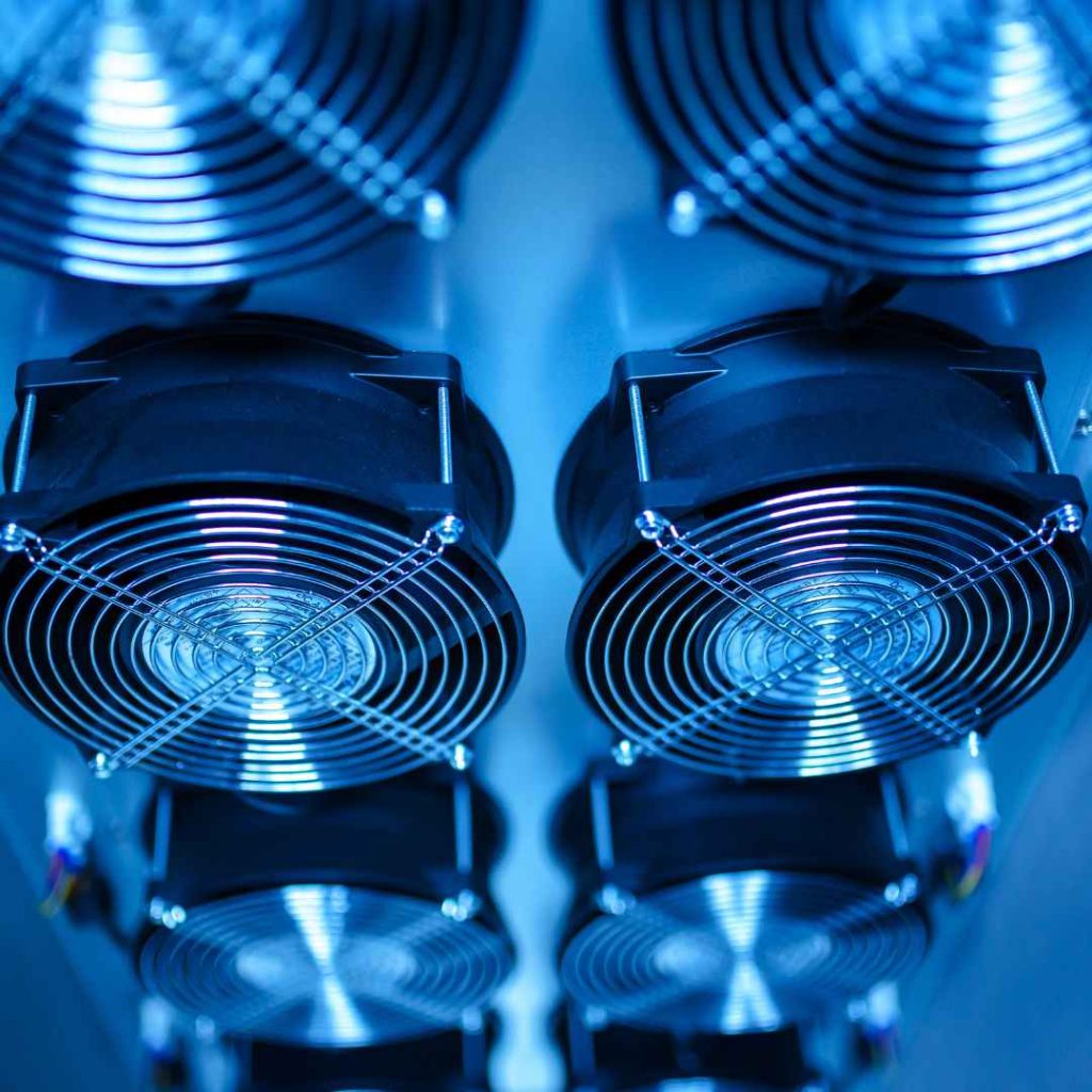 Close-up of multiple axial cooling fans with protective grilles, key components for optimizing airflow within electronic enclosures.